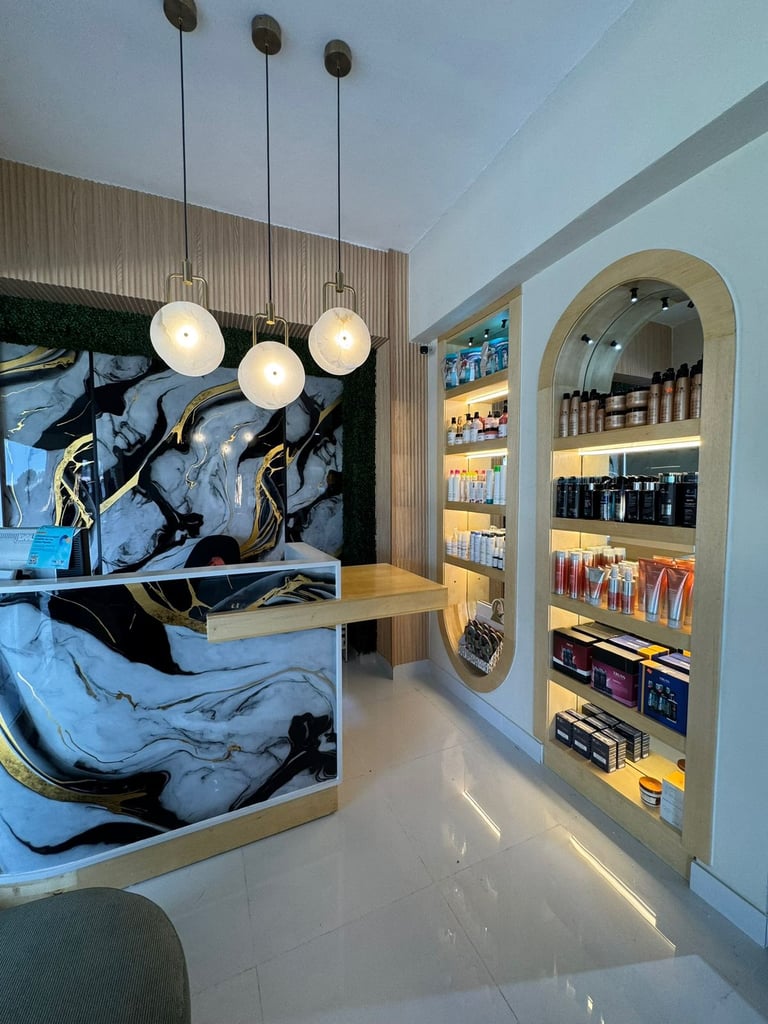 Modern cosmetics retail shop with blue abstract artwork display, three pendant lights, arched wooden shelving with products, and polished white flooring